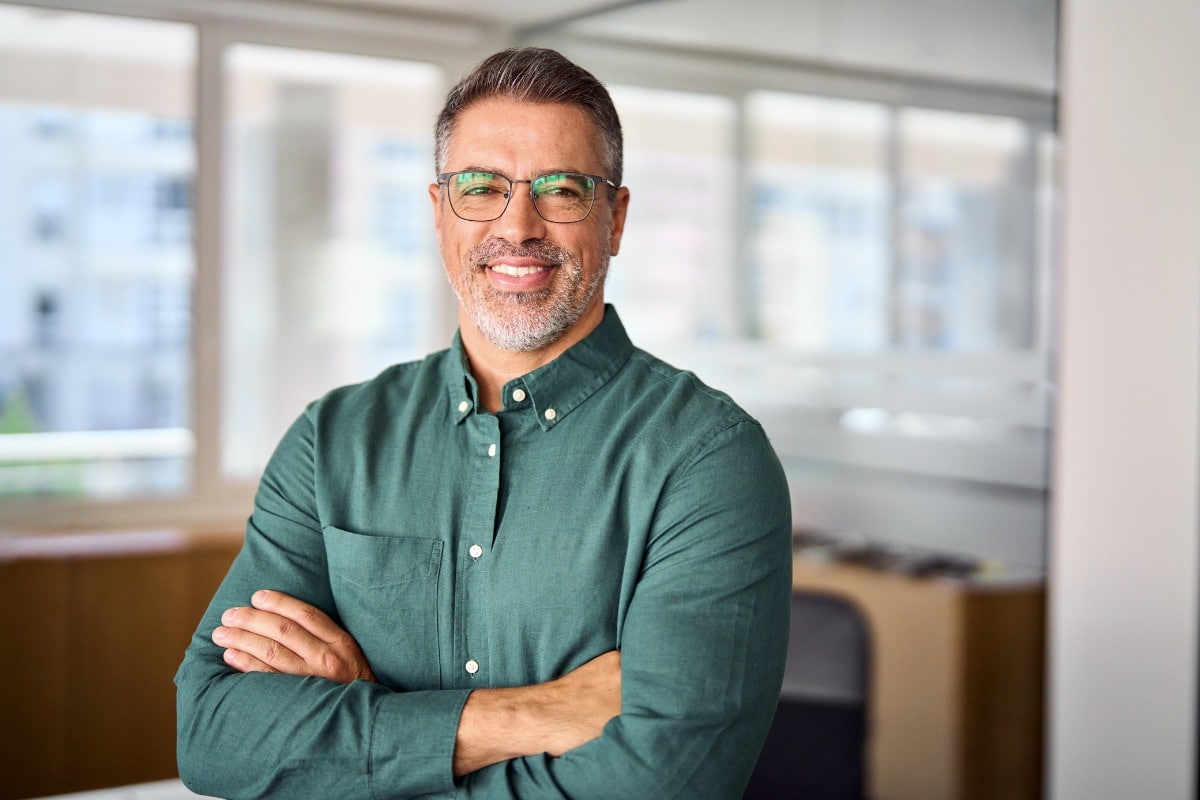 Man standing smiling with arms crossed