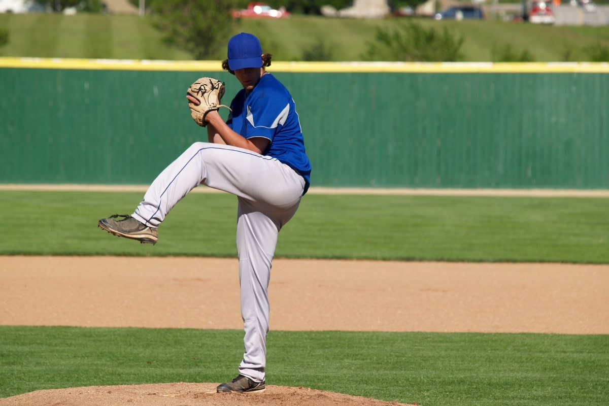 Boy pitching baseball