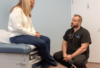 Physician at the weigh station meeting with a patient, representing customized weight loss plans