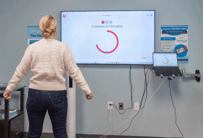 A woman standing in front of a screen, representing physician-led weight loss program